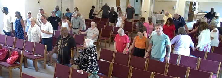 Members of Messiah praying together during service